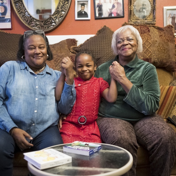Multigenerational family holding hands.